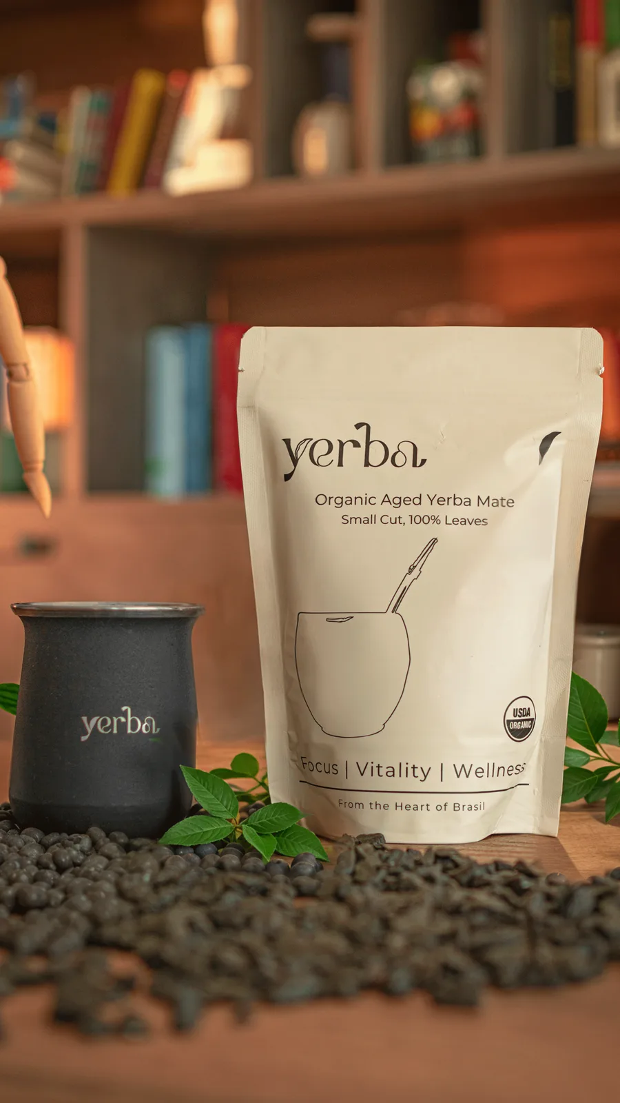 Yerba organic maté pouch beside a black stainless steel gourd