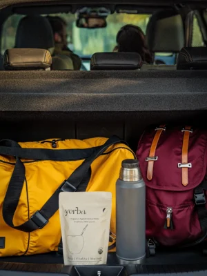 Yerba thermos and mate pouch packed in the boot of a car